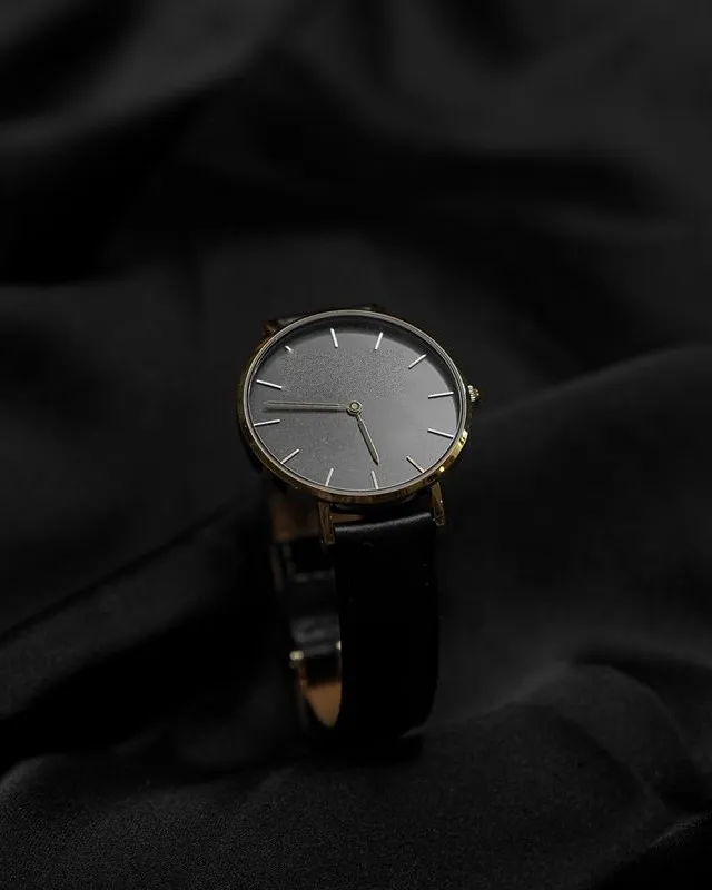 Osmund 36 Noir with a matte black dial and gold-toned case on black fabric